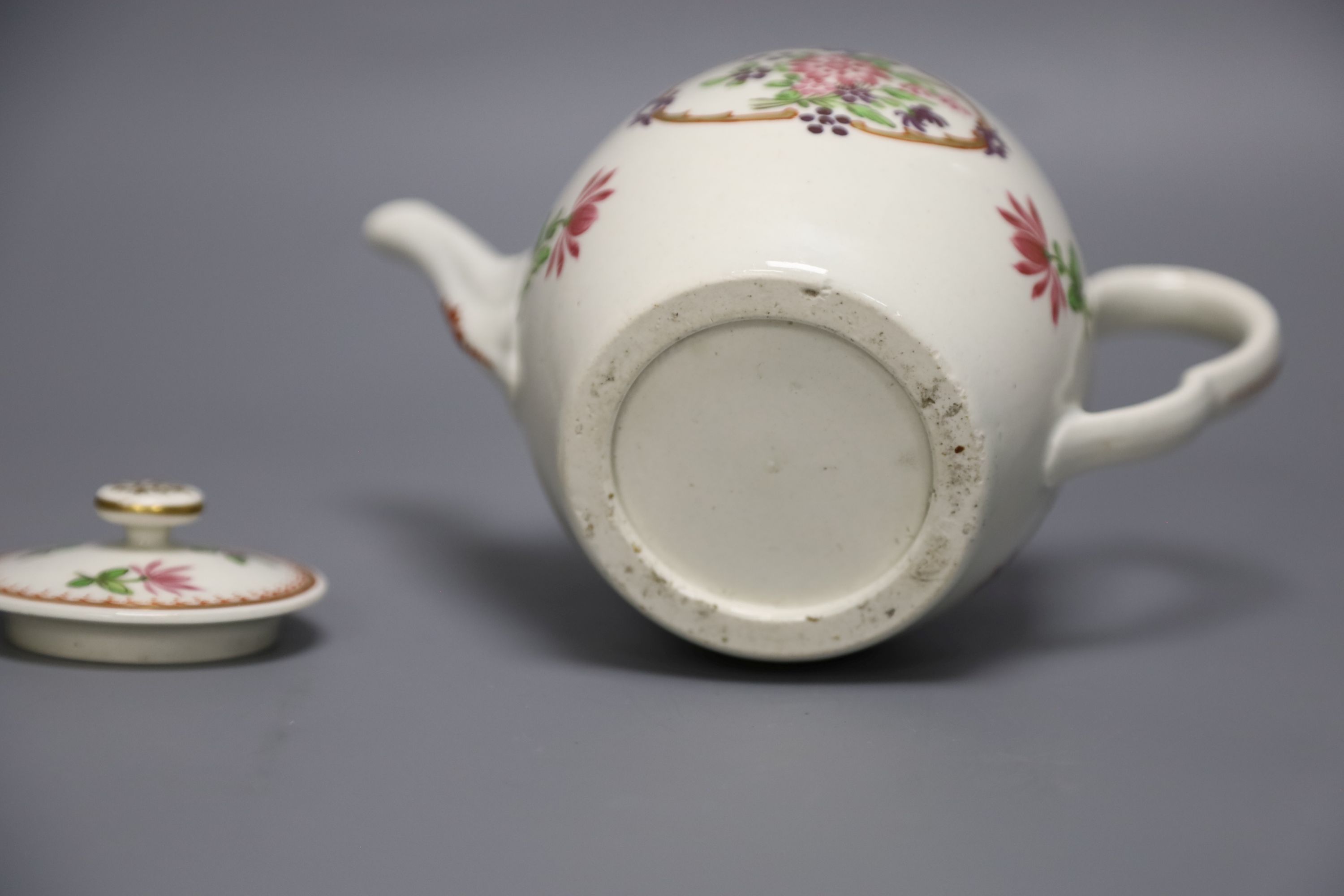 An 18th century Worcester fine teapot and cover of Companie des Indes type painted with Chinese flowers, height 12cm